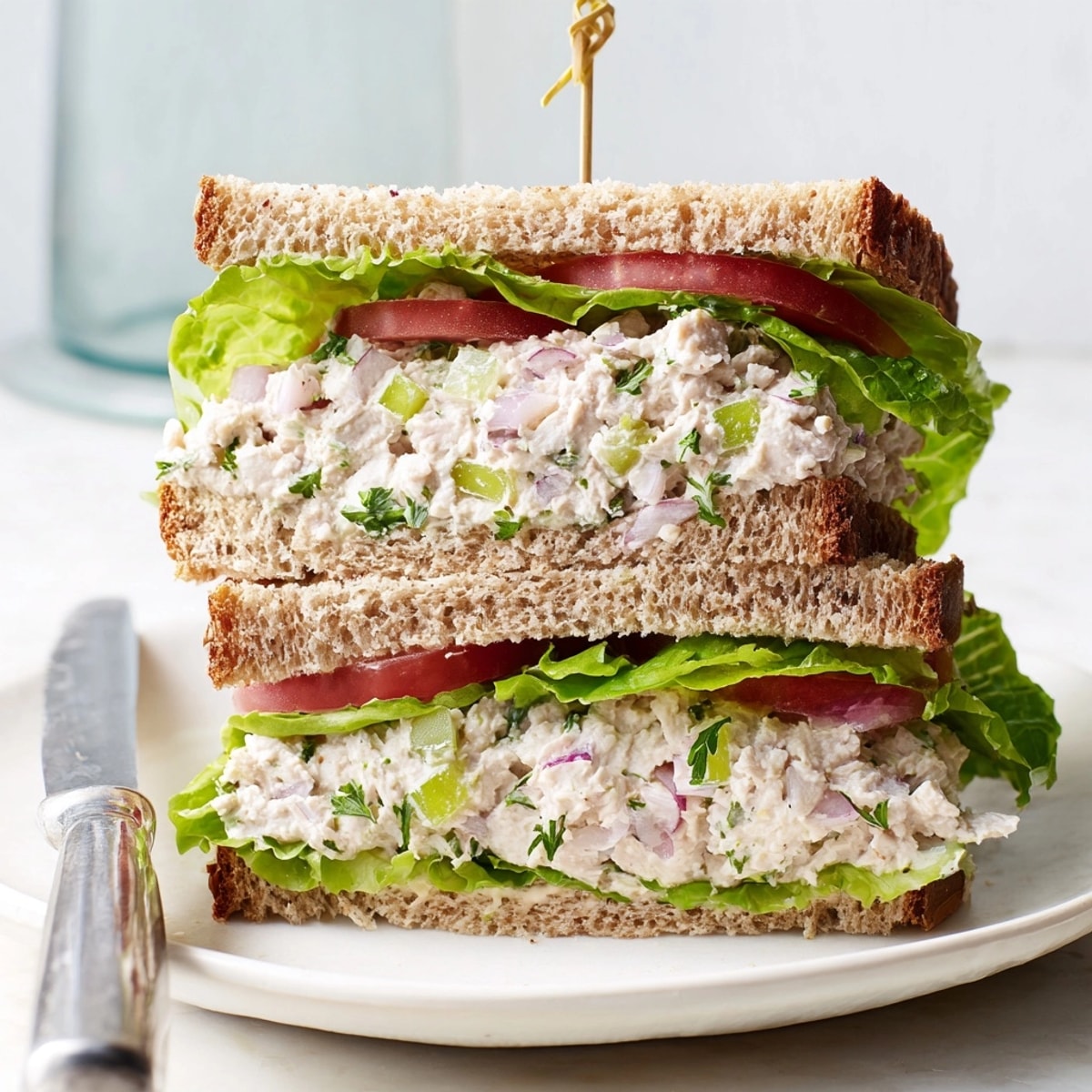 Creamy tuna salad sandwich featuring flaky tuna, crunchy celery, and toasted golden bread.