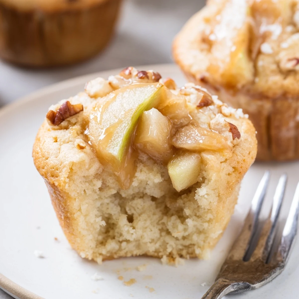 Freshly baked Caramel Apple Chunk Muffins, bursting with warm apples and gooey caramel.