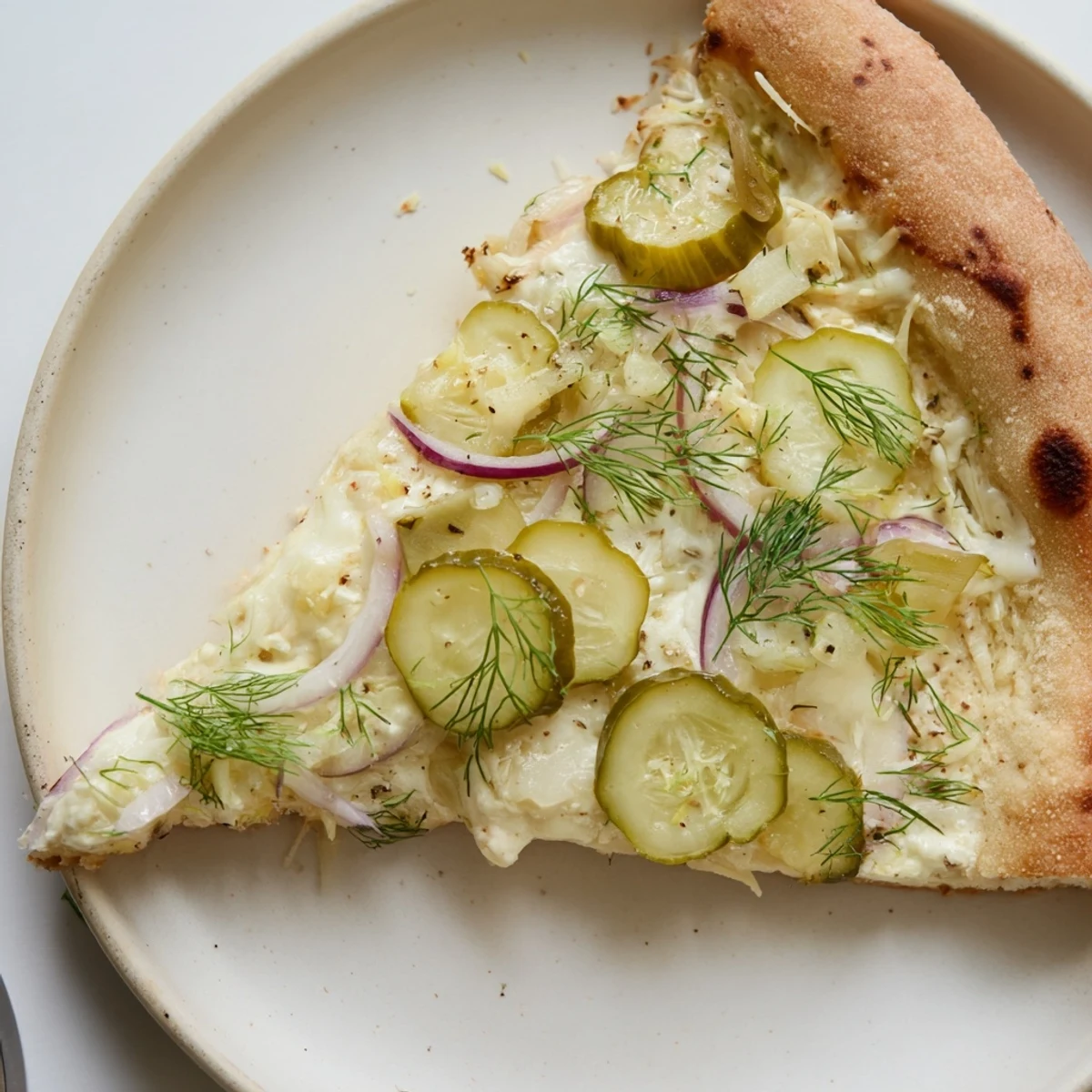 Tangy pickle pizza topped with creamy sauce, mozzarella, and crunchy dill pickles.  