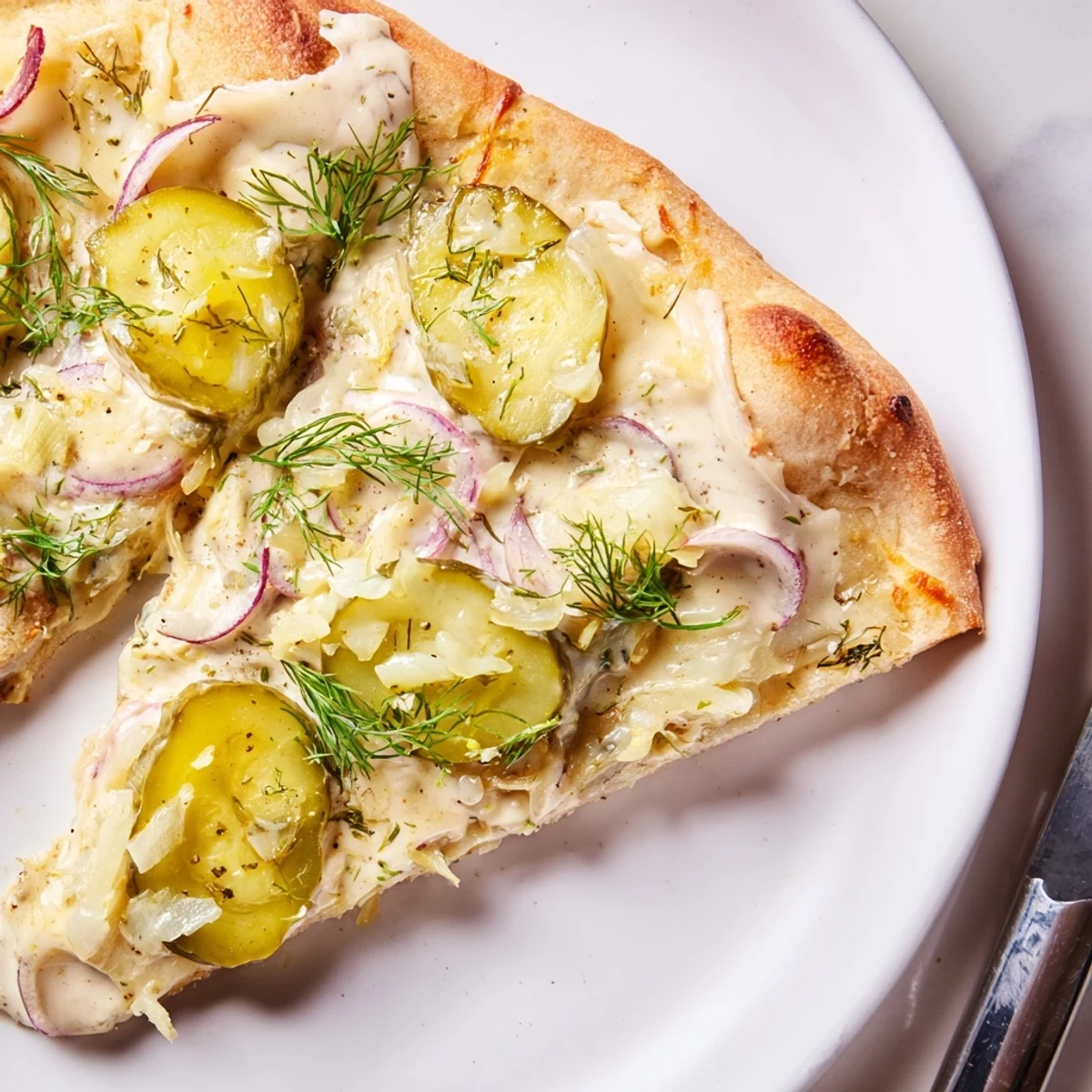 Deliciously unique pickle pizza, featuring rich crème fraîche and bubbling cheese.  