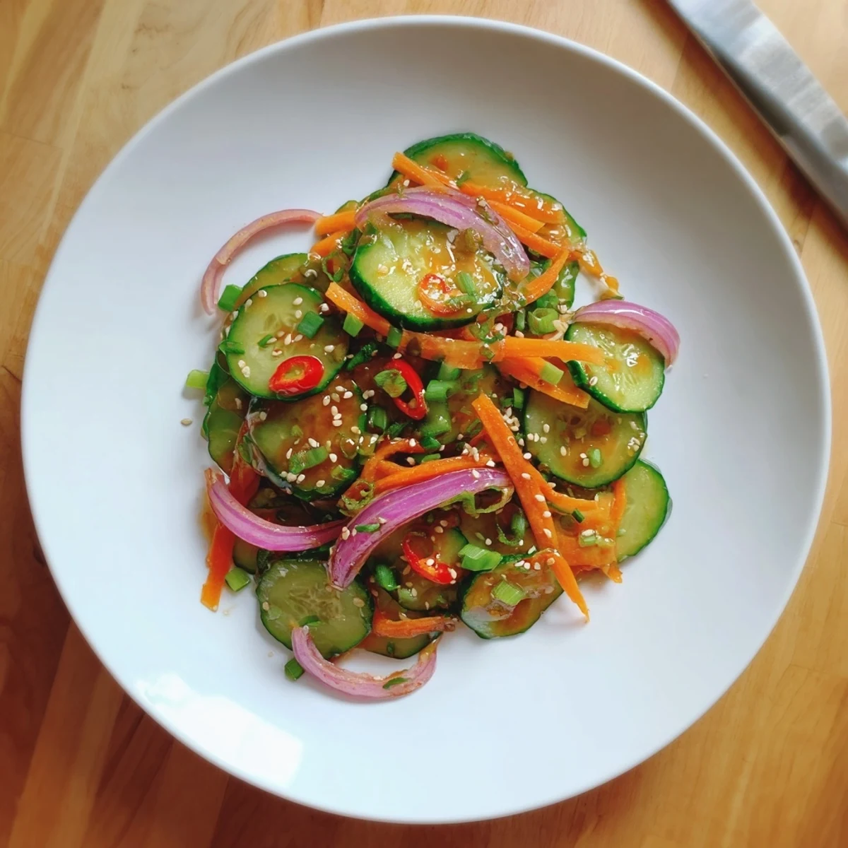 Refreshing cucumber salad remix, layered with colorful veggies and a zesty Asian dressing.  
