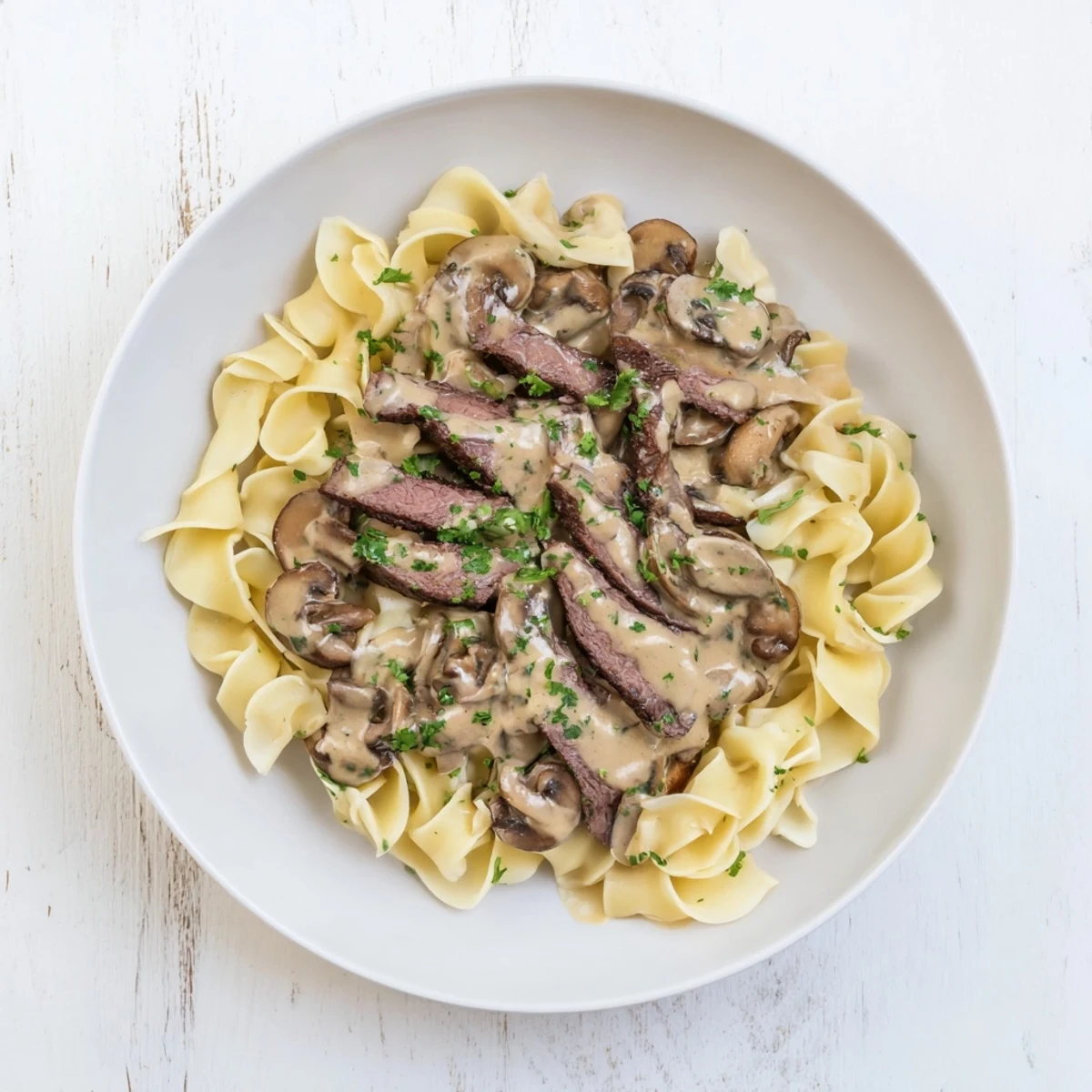 Sizzling strips of beef in this creamy Beef Stroganoff with tender mushrooms, ready to be enjoyed.
