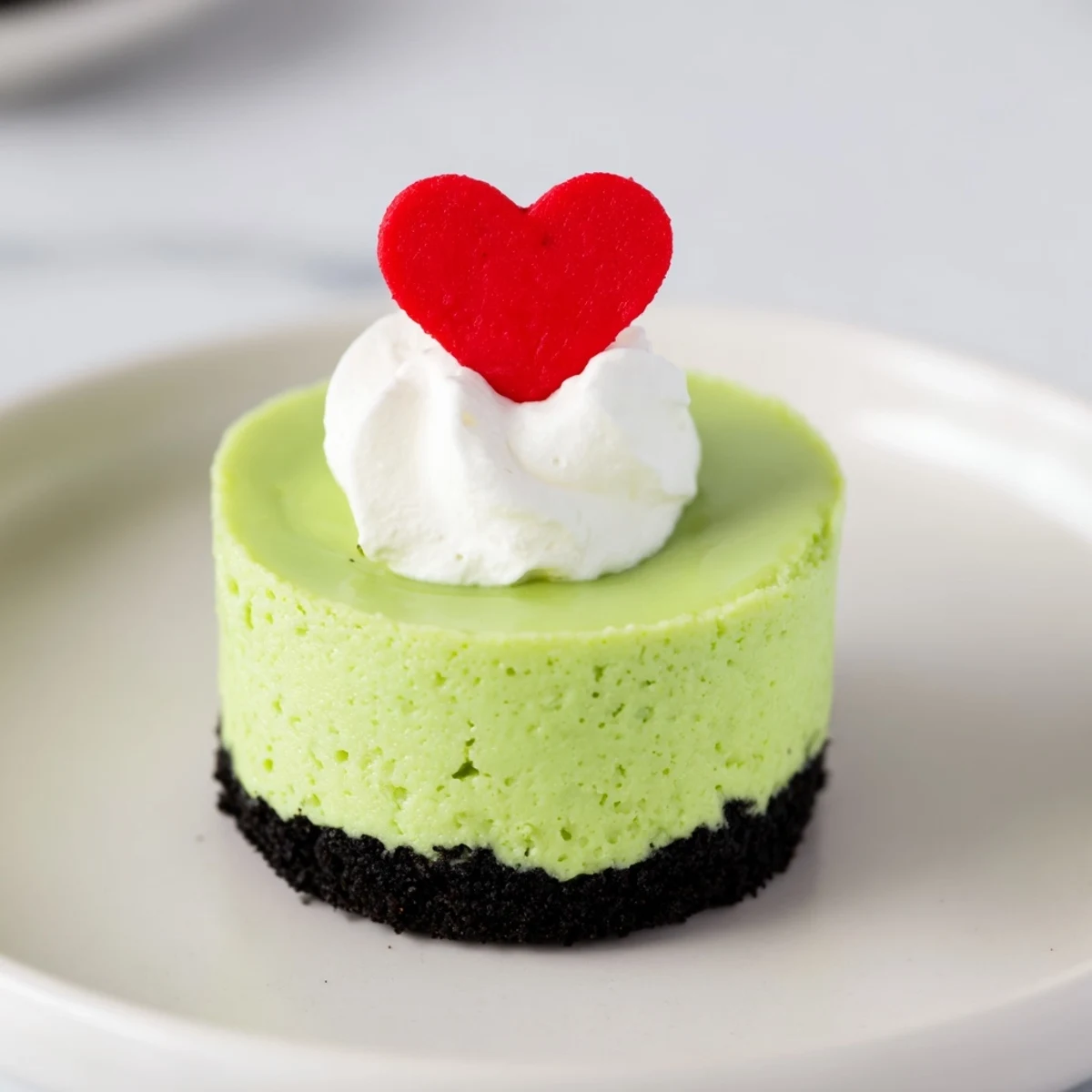 These individual Grinch Mini Cheesecakes are creamy, rich, and perfect for your holiday celebration.