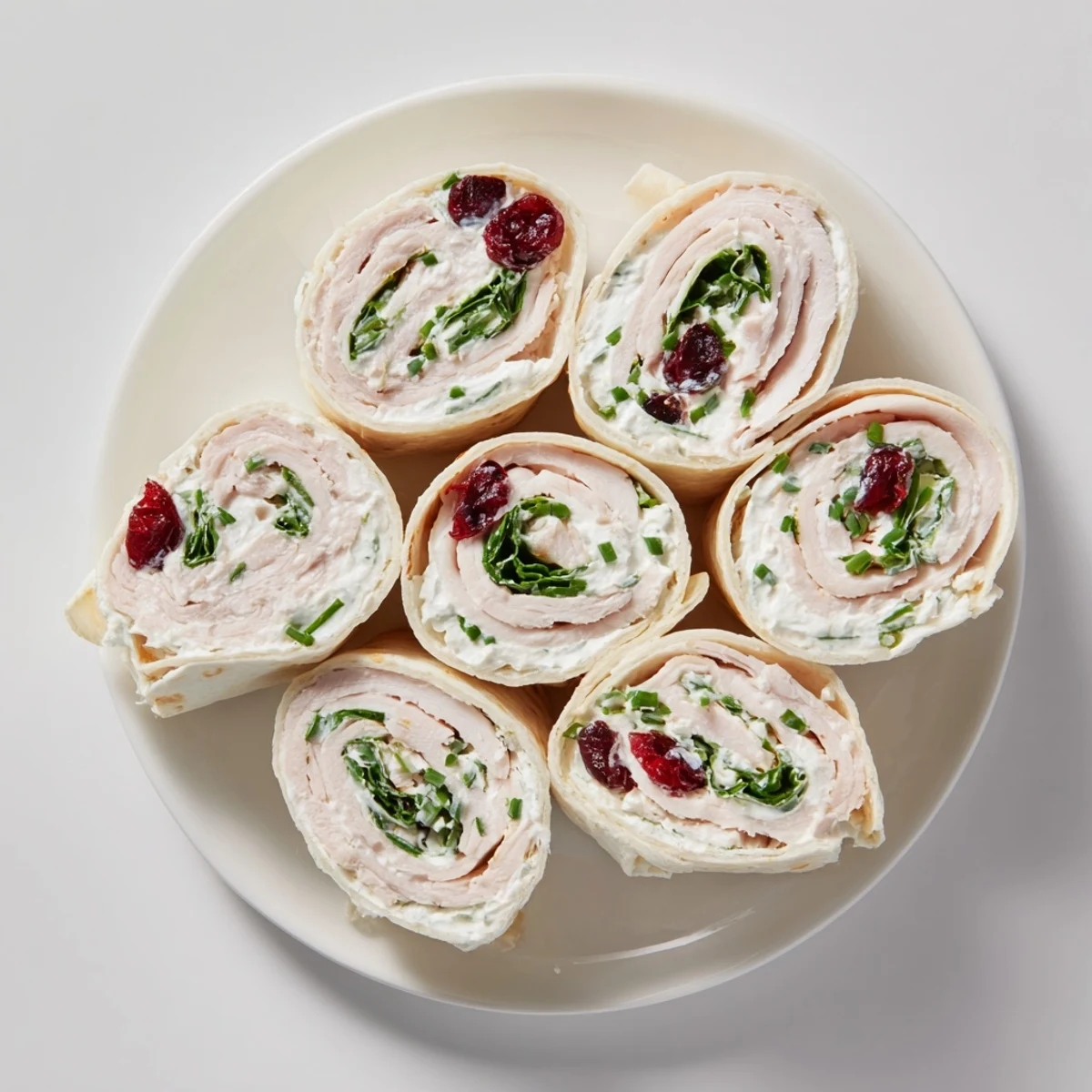 Beautifully arranged Simplified Turkey Cranberry Pinwheels, a tasty and quick appetizer perfect for gatherings.