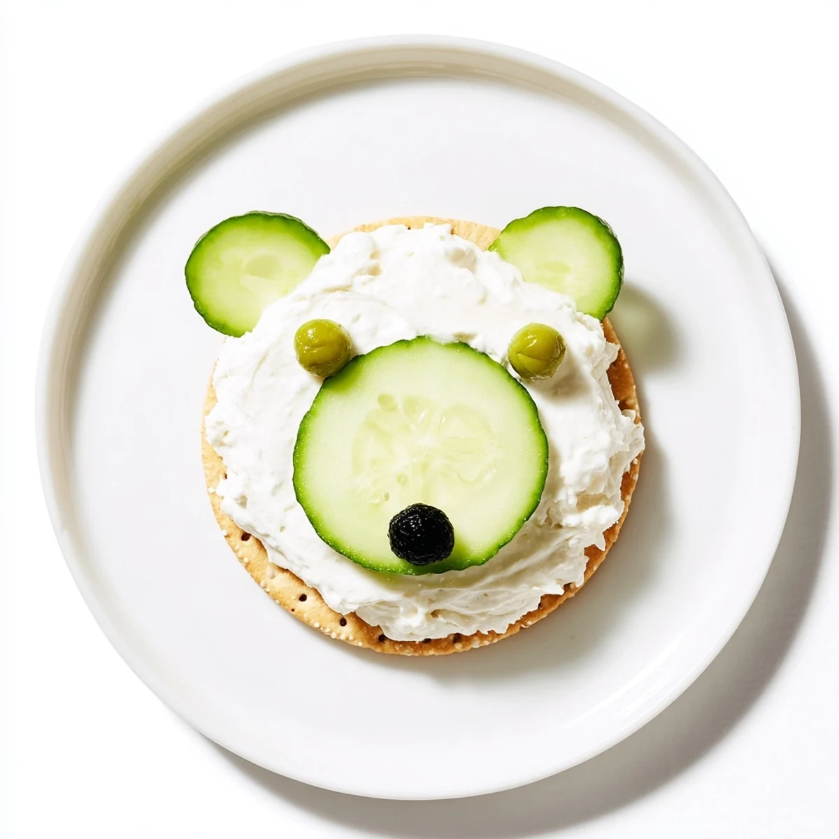Creamy Polar Bear Iceberg Cracker Stacks featuring crisp cucumbers, capers eyes, and radish ears—a fun appetizer.
