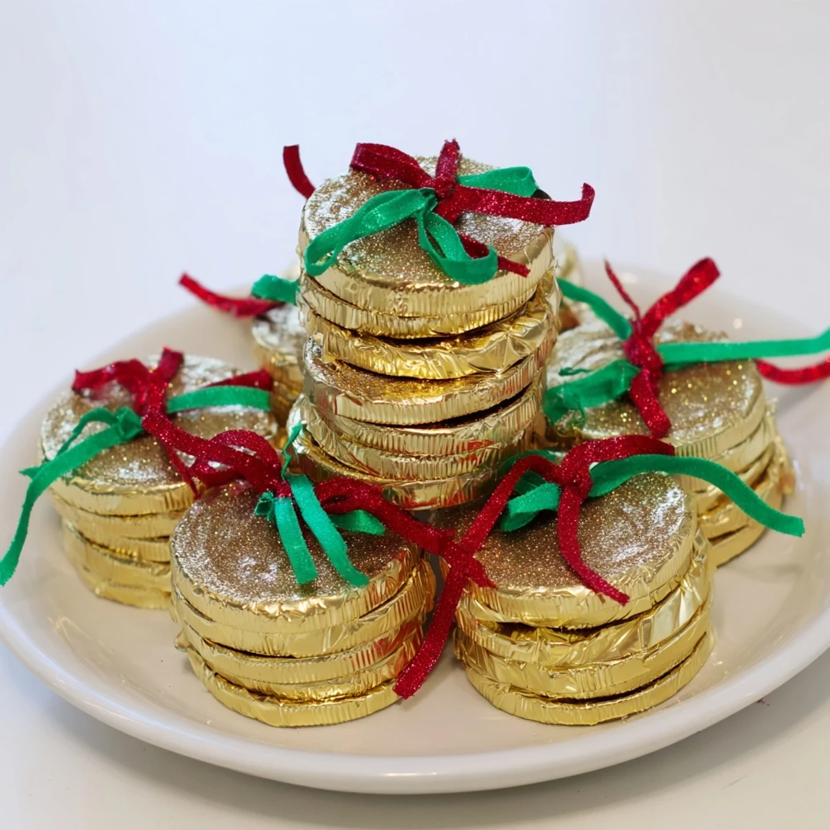 Shimmering gold chocolate coin stacks, a festive dessert centerpiece, ready for a special celebration.
