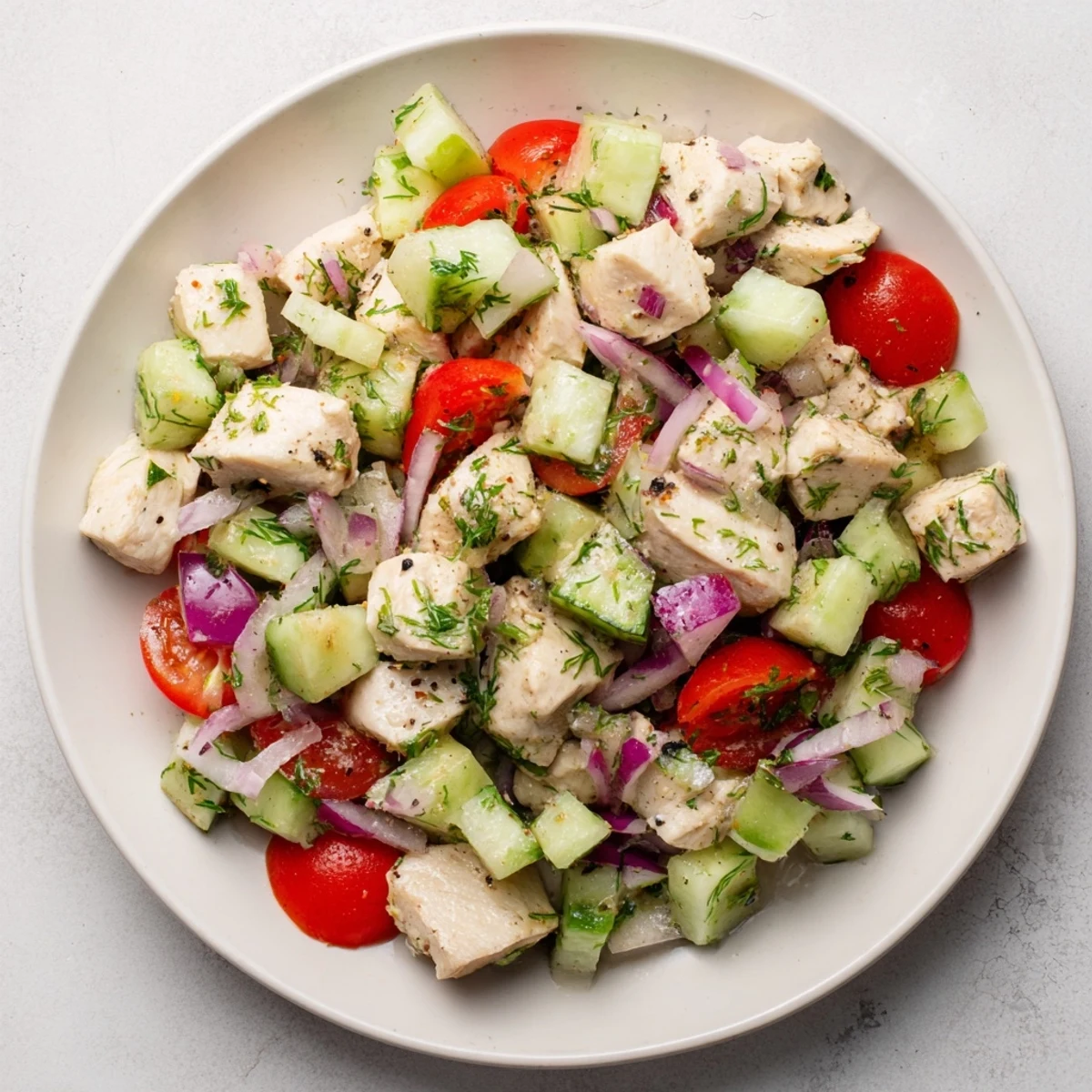 Vibrant Cucumber and Chicken Clean Shaker salad showing fresh herbs and juicy tomatoes for a healthy meal.