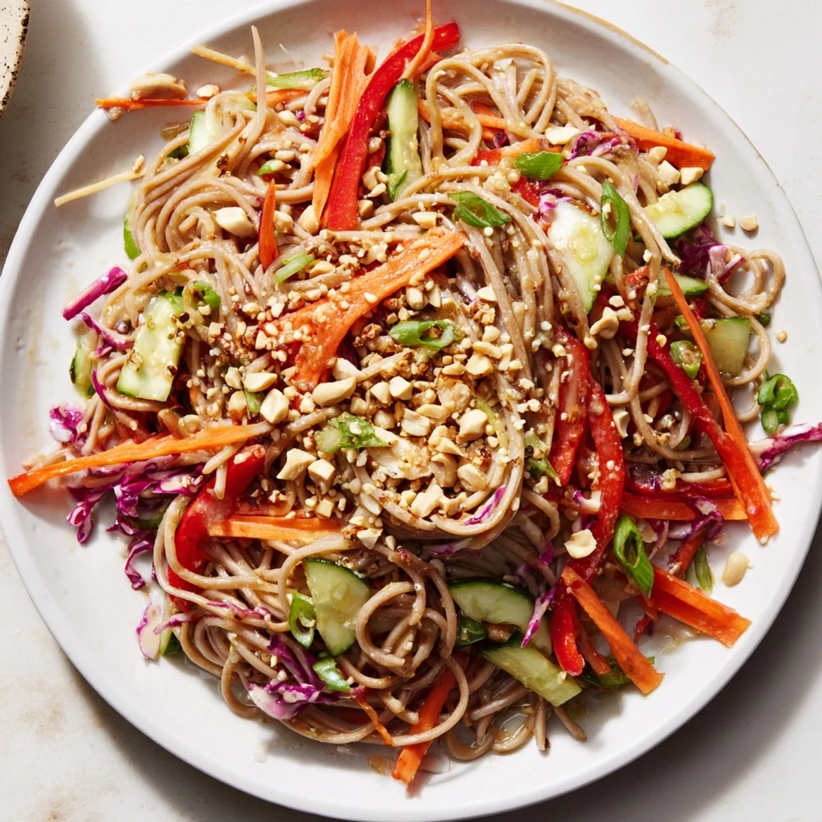 Freshly tossed Cold Noodle Salad with ribbons of red pepper and cilantro, ready for a light Asian meal.