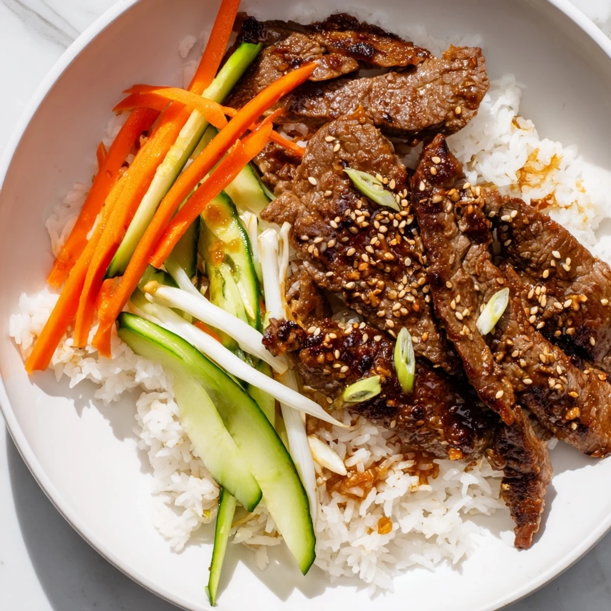 Sizzling bulgogi beef bowl featuring tender marinated beef, vegetables, and rice, ready to eat.