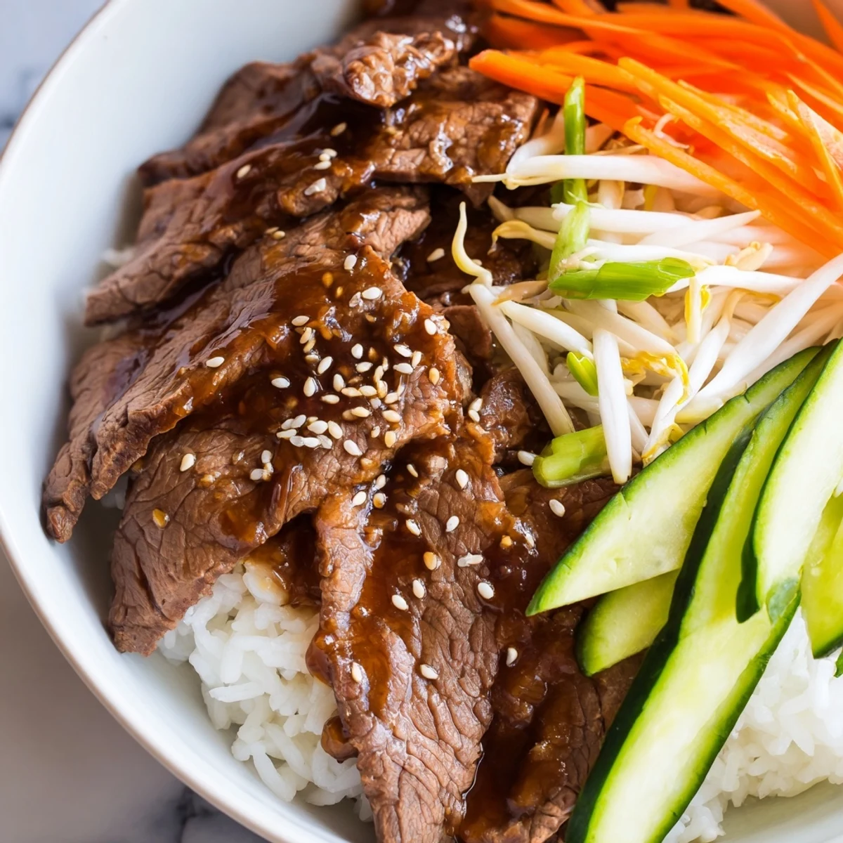 Savory bulgogi beef bowl with glistening, marinated beef strips, served on a bed of fluffy white rice.