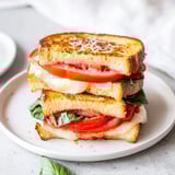 Crispy Air Fryer Pizza Margherita Grilled Cheese brimming with tomatoes, flavorful pizza sauce, and gooey cheese.
