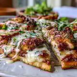 Freshly chopped romaine and creamy Caesar dressing crown cheesy Garlic Naan Chicken Caesar Pizzas served warm on a golden-brown naan crust.