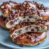 Golden-brown homemade bagels with a chewy texture, studded with rich chocolate chips for a satisfying, high-protein snack.  