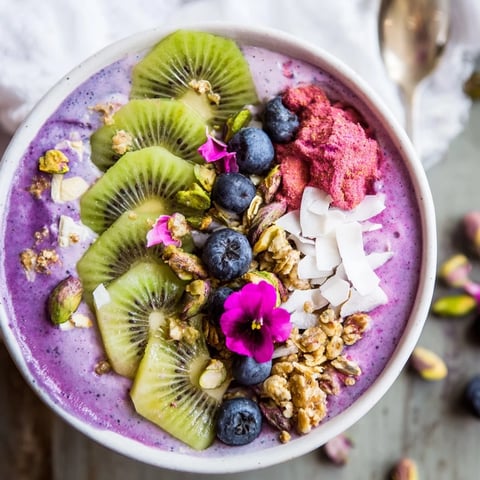 Vibrant smoothie bowls filled with purple yam and fresh fruits for breakfast delight.  