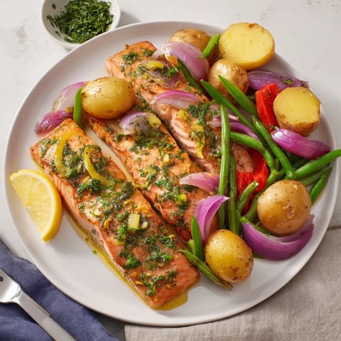 Tender Lemon Herb Salmon & Potato Sheet Pan with vibrant roasted veggies and fresh herbs.  
