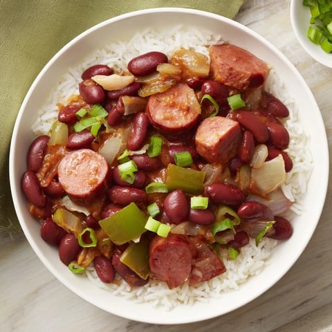 A steaming bowl of Red Beans & Rice, showcasing the creamy texture and vibrant flavors.