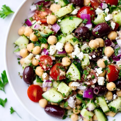 Mediterranean Chickpea Salad, bursting with fresh cucumbers, tomatoes, olives, and feta, ready to enjoy.