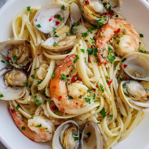 Delicious seafood linguine with shrimp, clams, and mussels in a garlic-wine sauce, ready to serve.