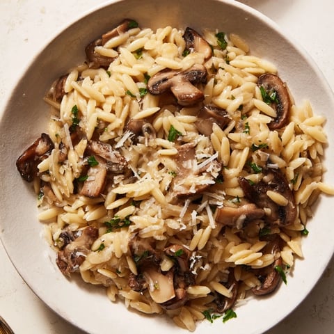 Creamy orzo mushroom risotto-style, plated beautifully with grated Parmesan, ready to eat and enjoy.