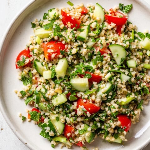 Text: A close-up of a vibrant Bulgur Wheat Salad Tabbouleh, a fresh and herb-filled Middle Eastern delight.