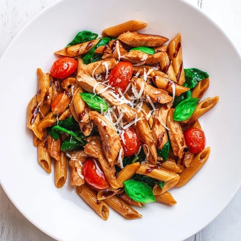 Tender chicken glazed in a tangy balsamic reduction, tossed with al dente penne, garlic, and fresh cherry tomatoes in a skillet.  
