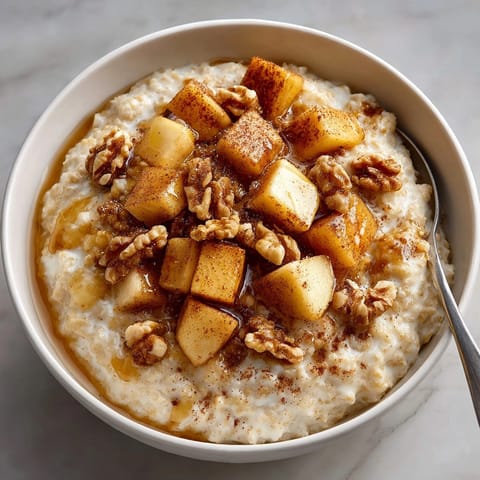 A close-up of Warm Spiced Apple Oatmeal, showing a delicious, homemade, warm morning meal.