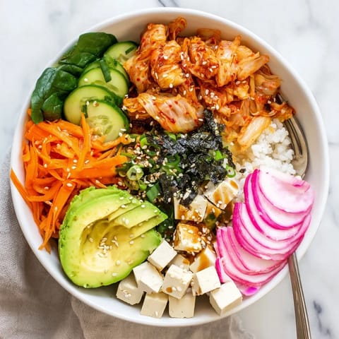 Delicious fermented vegetable bowl featuring tangy kimchi, grains, and vibrant veggies.  