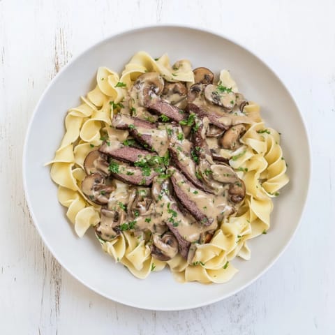 Sizzling strips of beef in this creamy Beef Stroganoff with tender mushrooms, ready to be enjoyed.