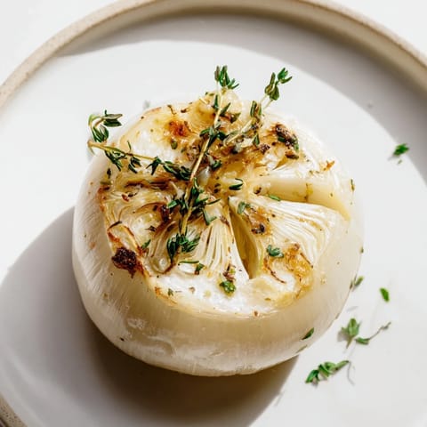 Fragrant Onion Boil, showcasing tender, roasted Vidalia onions topped with fresh parsley and herbs.