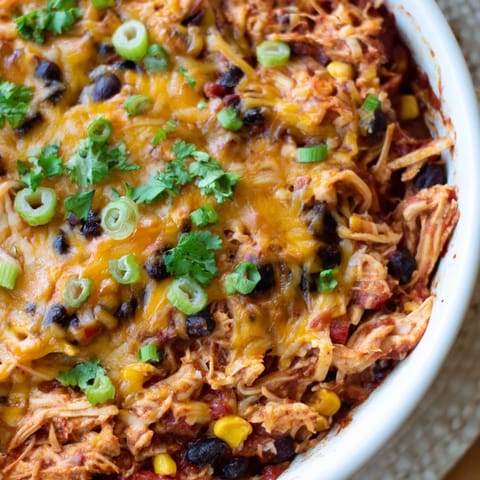 Golden, bubbly cheese blankets the top of this flavorful Chicken Enchilada Skillet, a one-pan meal delight.