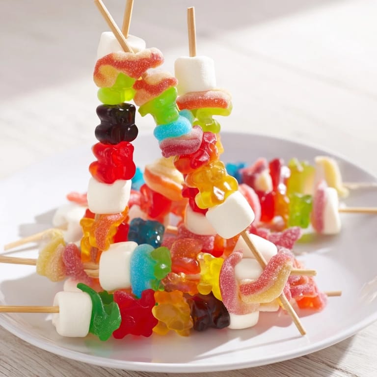 Vibrant Gummy Candy Kabobs, featuring gummy worms, bears, and rings skewered for easy enjoyment.