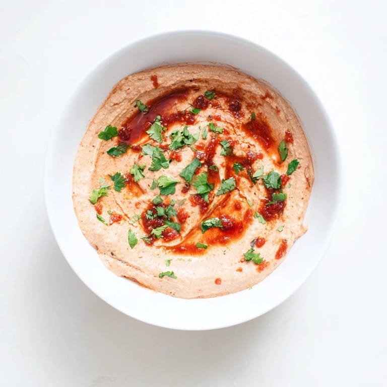 A vibrant bowl of Spicy Black Bean Dip, perfectly blended for easy scooping with veggies.