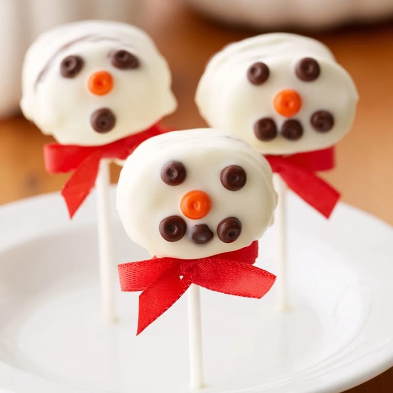 These adorable Express Snowman Marshmallow Pops feature bright orange noses and chocolate button details.