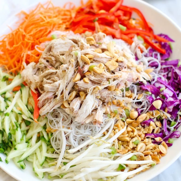 A close-up of the fresh Vietnamese Crunch Noodle Salad, showing vibrant veggies and tender chicken.