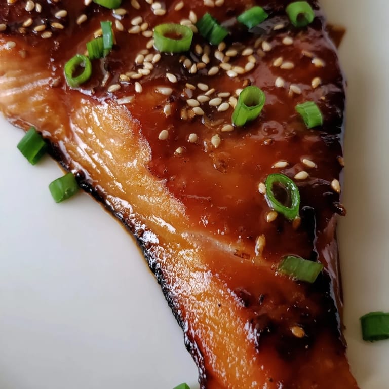 A close-up shot of perfectly cooked ginger soy glazed salmon, ready for your next dinner.