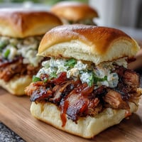 Tender pulled pork sliders with coleslaw, perfect for baby showers and festive gatherings.
